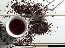 A cup of tea and some tea strainer on the table