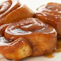 A close up of some cinnamon rolls on a plate