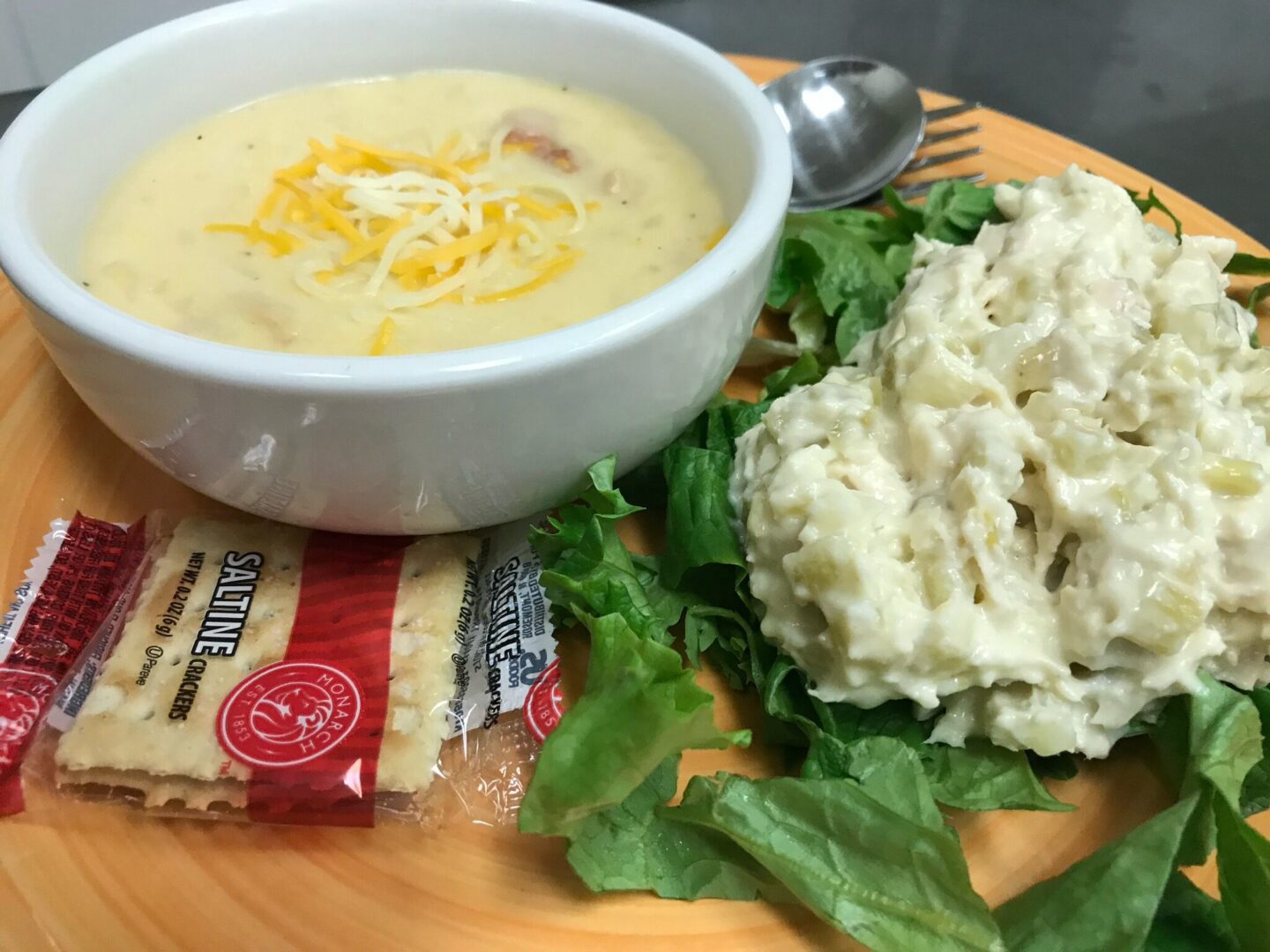 A bowl of soup and some food on the table.