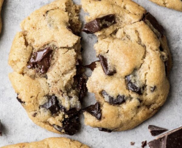 A cookie with one bite taken out of it.