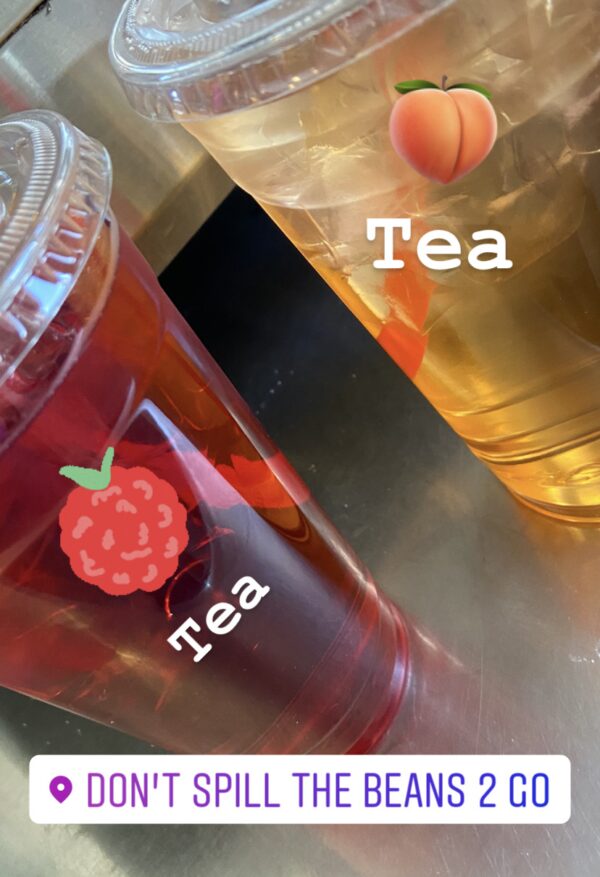 A close up of two cups with tea in them
