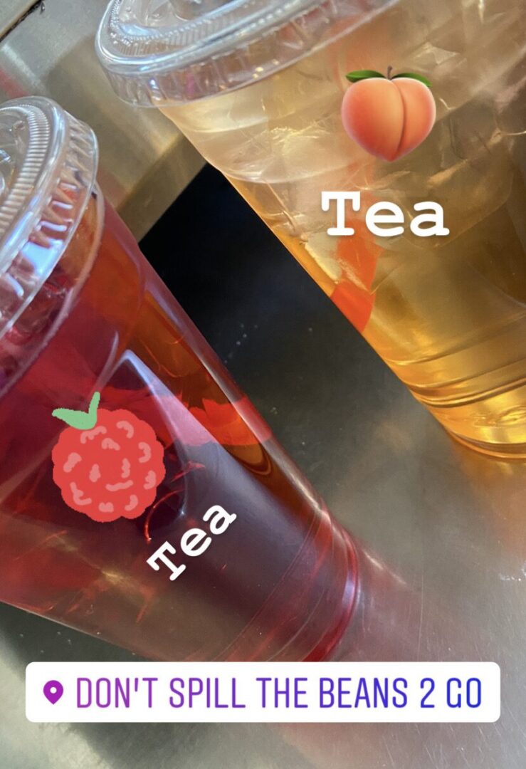 A close up of two cups with tea in them