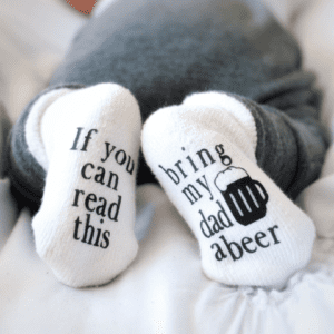 A person wearing socks with beer written on them.