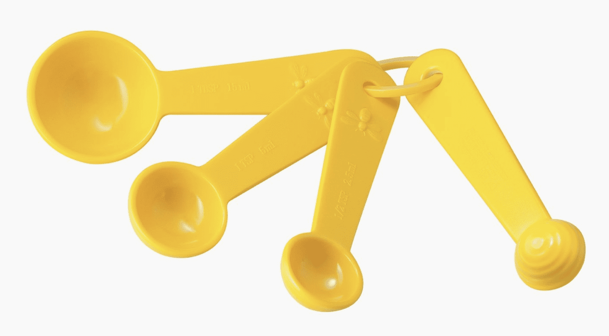 A yellow measuring spoon and cup set.