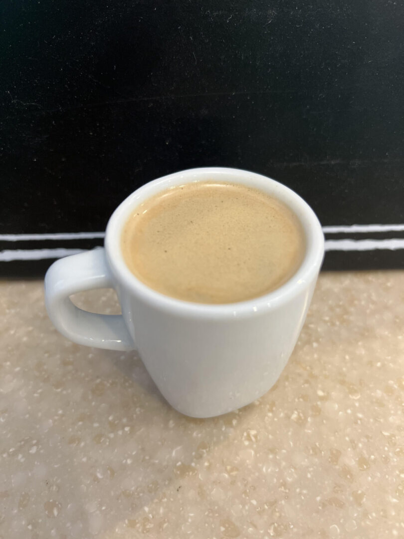 A cup of coffee sitting on top of a table.