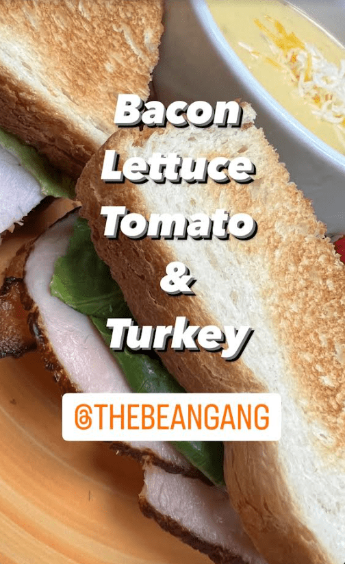 A sandwich with bacon lettuce tomato and turkey