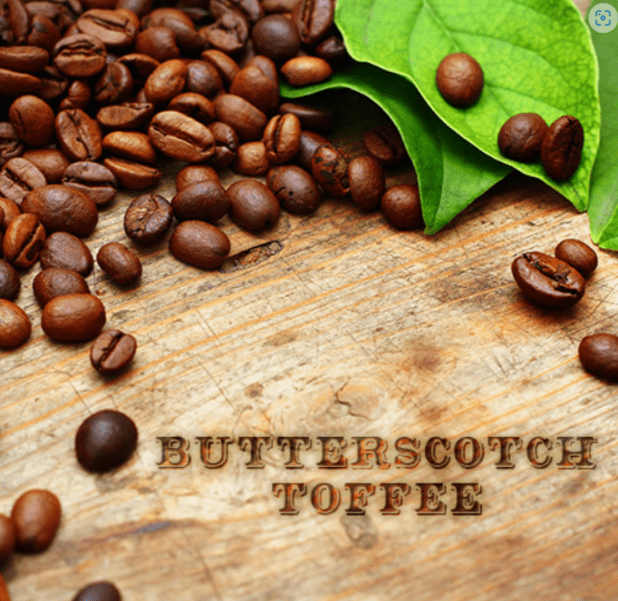 A wooden table topped with coffee beans and leaves.