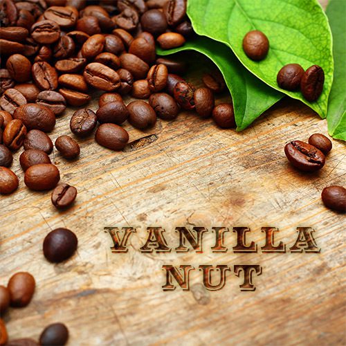 A wooden table topped with coffee beans and leaves.
