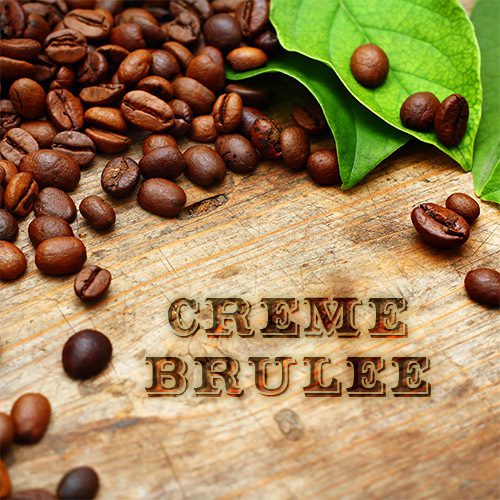 A wooden table topped with coffee beans and leaves.