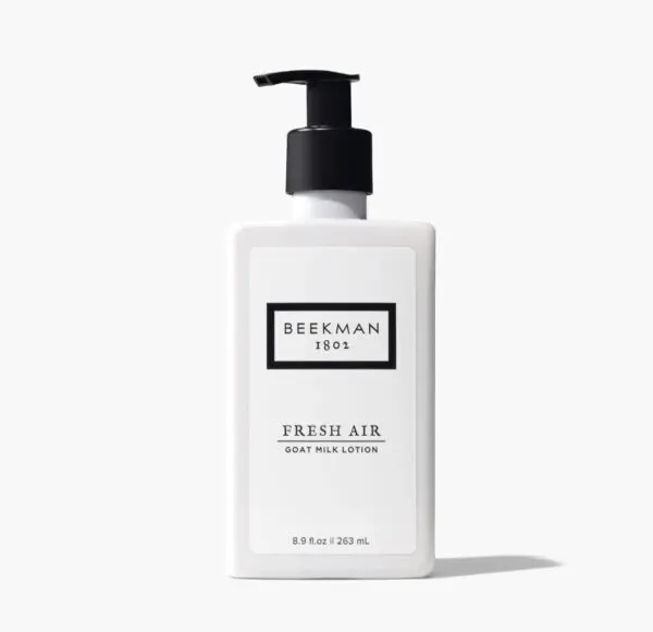 A bottle of hand lotion sitting on top of a table.