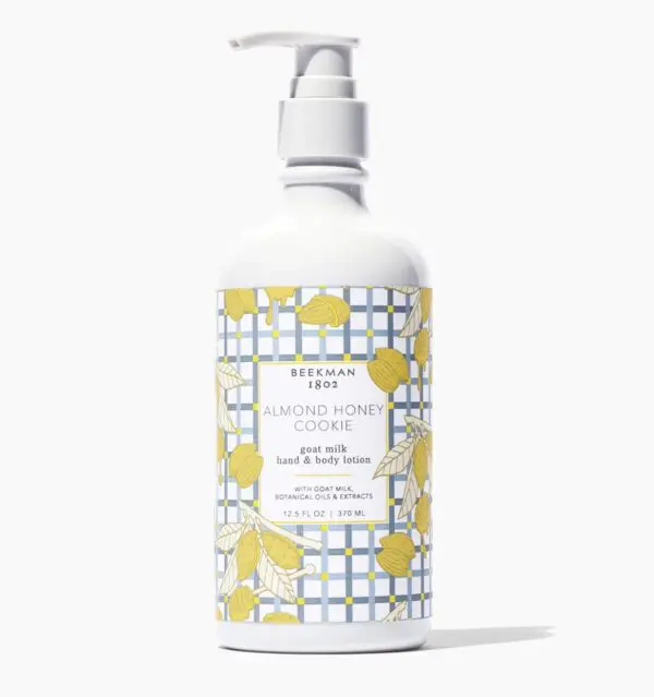 A bottle of lotion with yellow and white design.