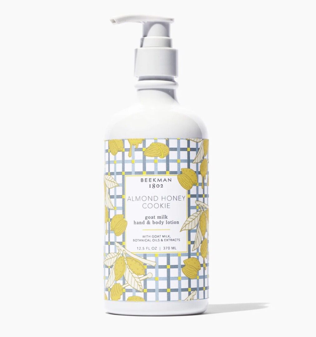 A bottle of lotion with yellow and white design.