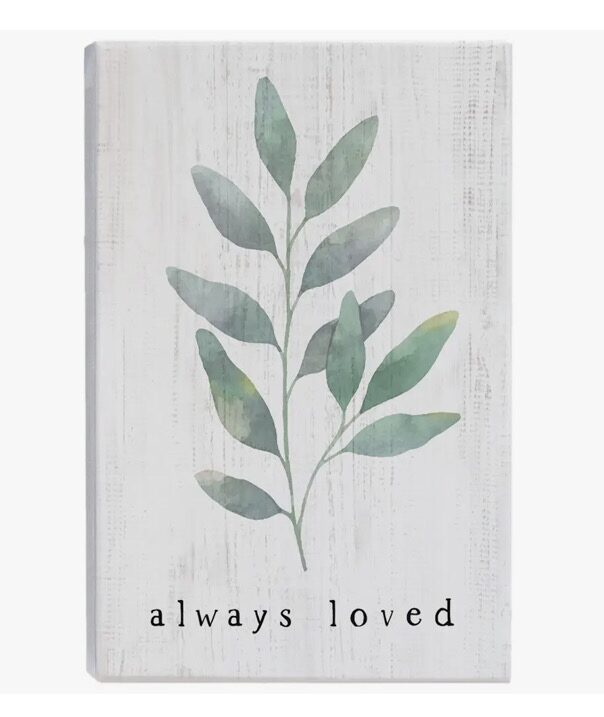 A wooden sign with leaves and the words " always loved ".