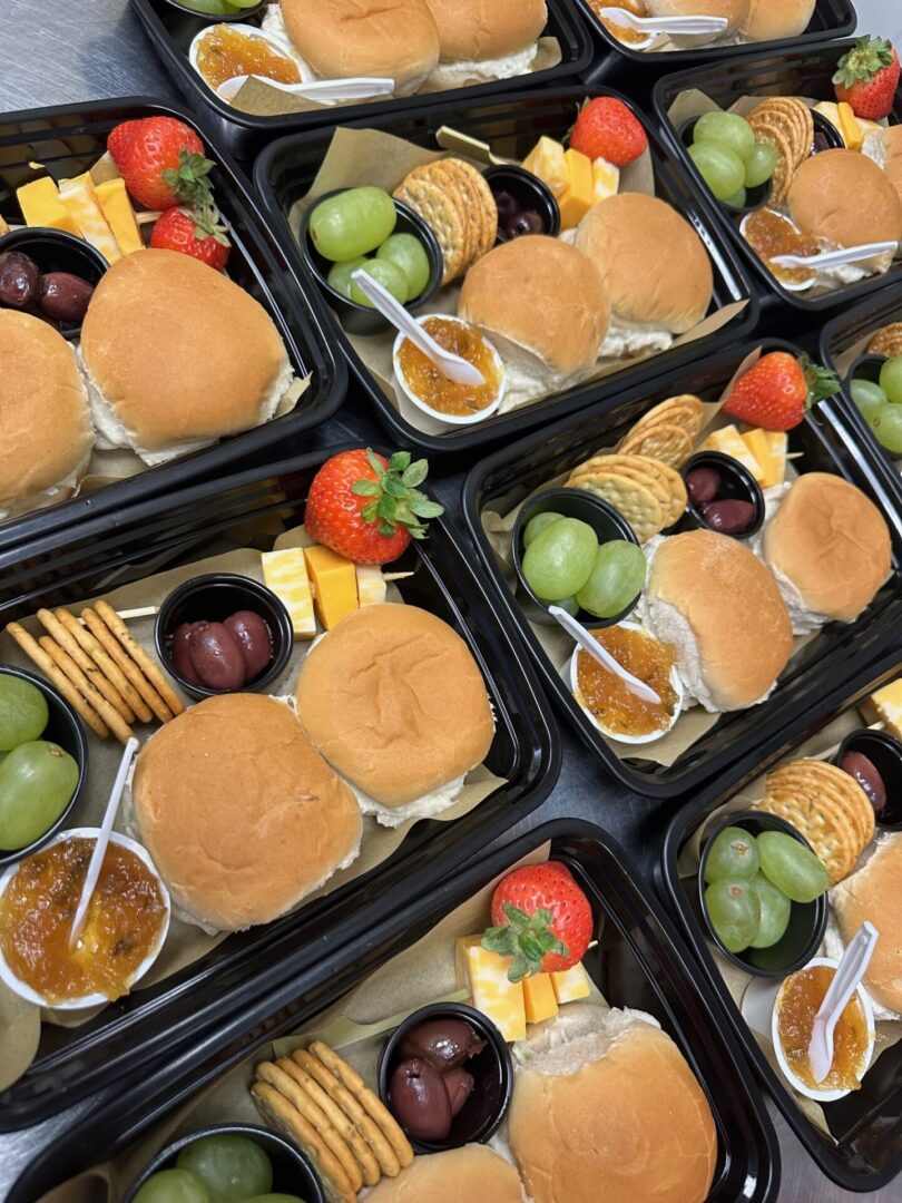 A bunch of food is in trays on the table