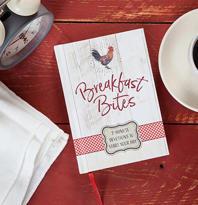 A book sitting on top of a table next to coffee.
