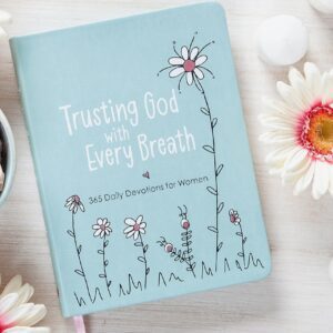 A book sitting on top of a table next to flowers.