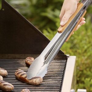 A hand uses BBQ Tongs to turn sausages on a grill.