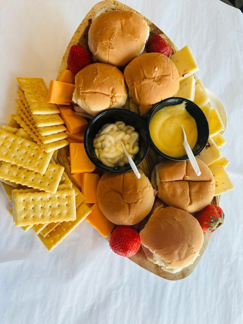 A tray of sandwiches and crackers with mustard.