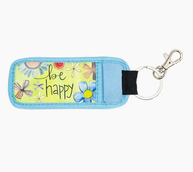 A key chain with a picture of flowers and the words " be happy ".