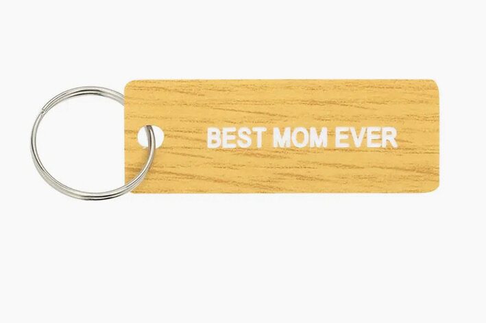 A wooden key chain with the words " best mom ever ".
