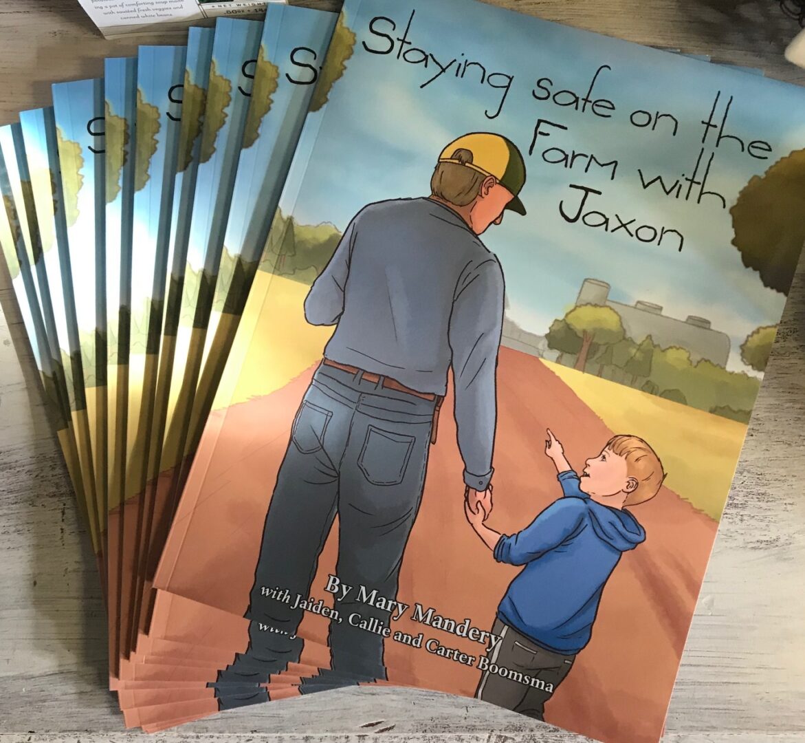 Stack of books titled "Staying Safe on the Farm with Jaxon" by Mary Mandery, featuring a man and child walking on a farm path.