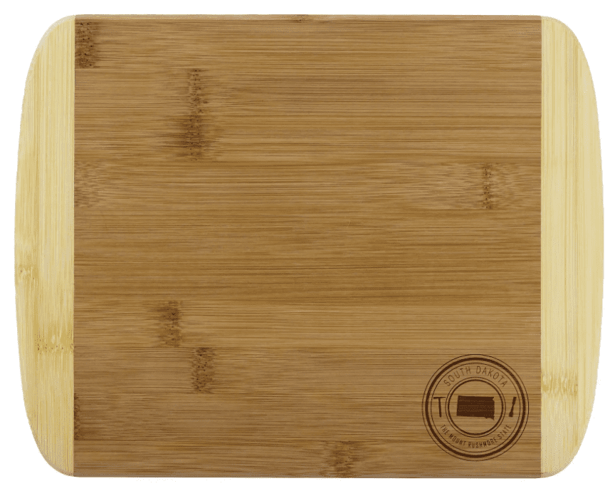A rectangular bamboo cutting board with a South Dakota emblem in the lower right corner.