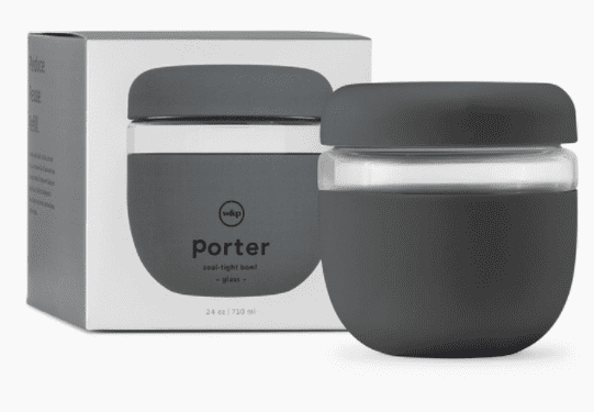 A black and clear glass Porter bowl with a lid is shown next to its packaging. The packaging displays an image of the bowl and product details.