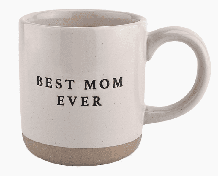 A beige mug with a handle, featuring the text "BEST MOM EVER" in black letters.