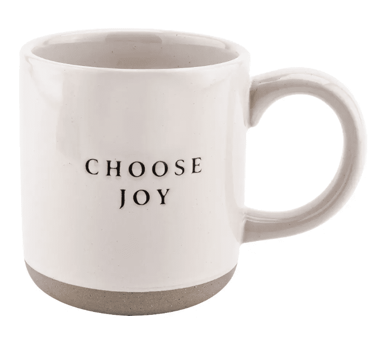 A white ceramic mug with "CHOOSE JOY" written in black text on one side.
