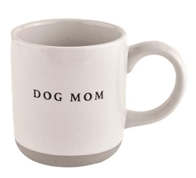 White ceramic mug with "DOG MOM" printed in black text.