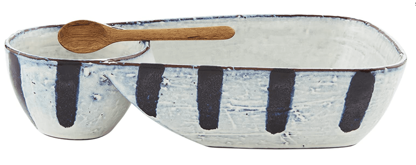 Ceramic serving set with divided large and small bowls featuring vertical stripes and a wooden spoon.