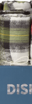 Rolled plaid kitchen towels in green, black, and white atop a blue surface with partial "DIS" text visible.