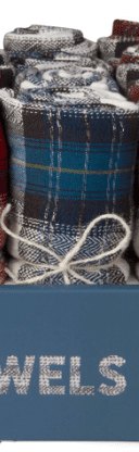 Rolled up plaid towels tied with string, displayed upright in a box labeled "Towels.