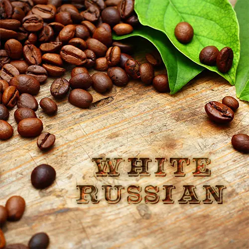Coffee beans and green leaves on a wooden surface with the text "White Russian.
