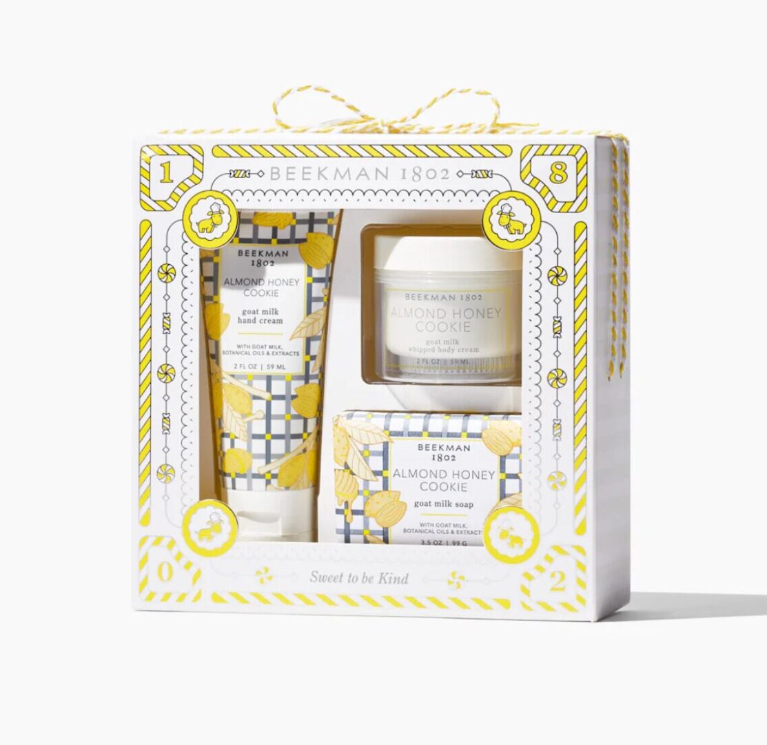 Beekman 1802 Almond Honey Cookie gift set with hand cream, body scrub, and soap bar, packaged in a decorative box.