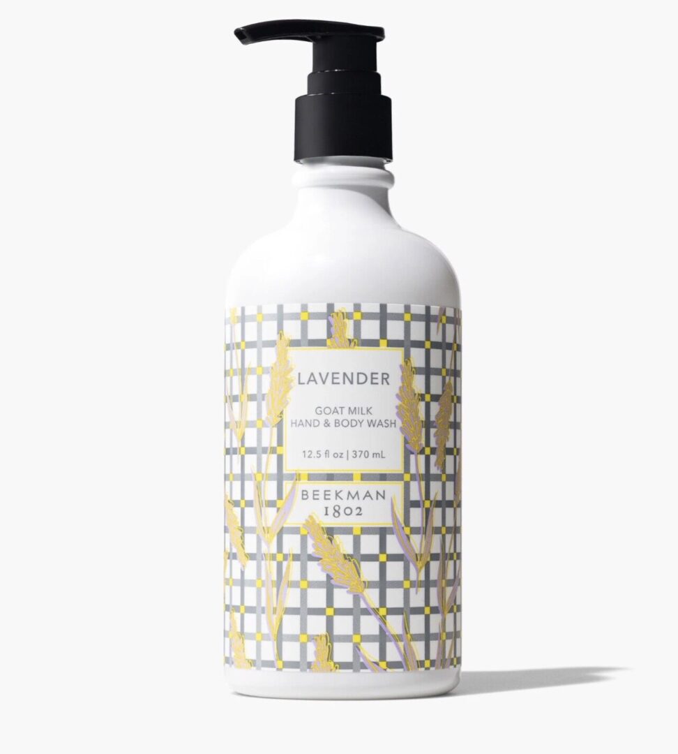A bottle of Beekman 1802 Lavender Goat Milk Hand & Body Wash, 12.5 fl oz, with a plaid pattern and lavender illustrations.