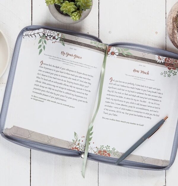 Open journal with decorated pages and pen.