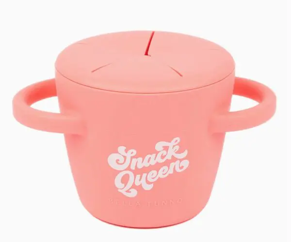 Pink snack container with two handles and a lid featuring the text "Snack Queen Bella Tunno.