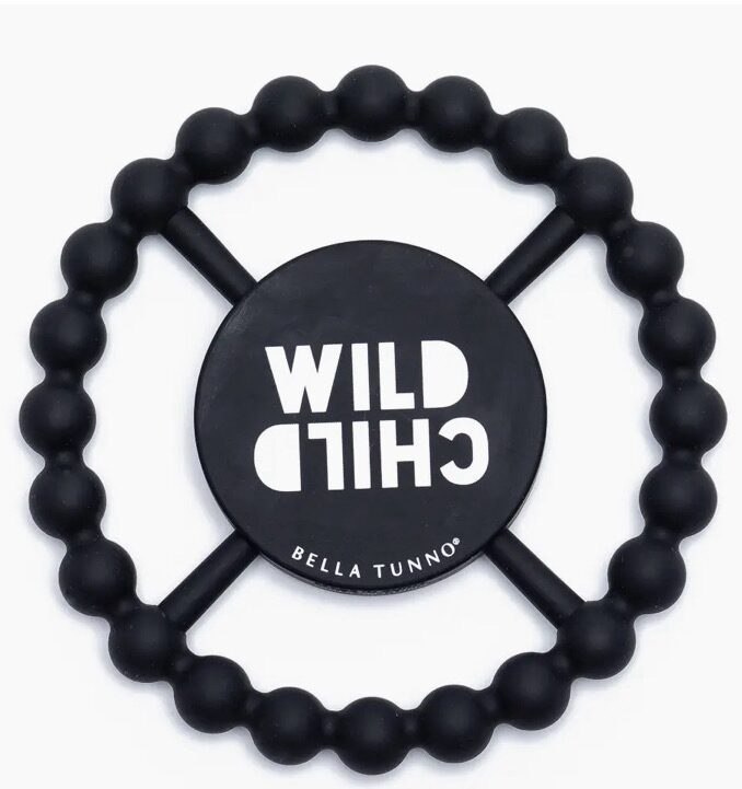 A black circular teething toy with beaded edges, featuring the text "Wild Child" and "Bella Tunno.