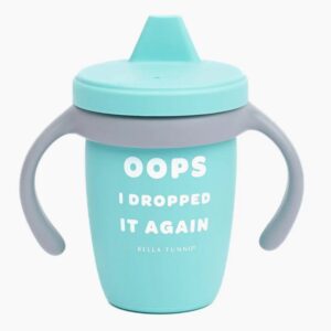 A teal sippy cup with a gray handle and a humorous message, "Oops I Dropped It Again," printed in white text.