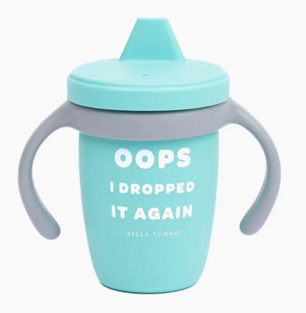 A teal sippy cup with a gray handle and a humorous message, "Oops I Dropped It Again," printed in white text.