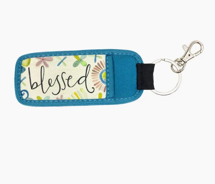 Blue keychain with a floral design and the word "blessed" in cursive text.