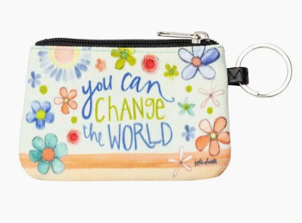 A coin pouch with floral designs and the phrase "You can change the world." It has a zipper and a metal keyring attached.