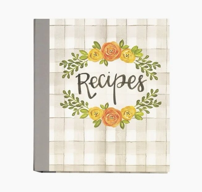 A recipe book with a floral design and the word "Recipes" in the center on a checkered background.