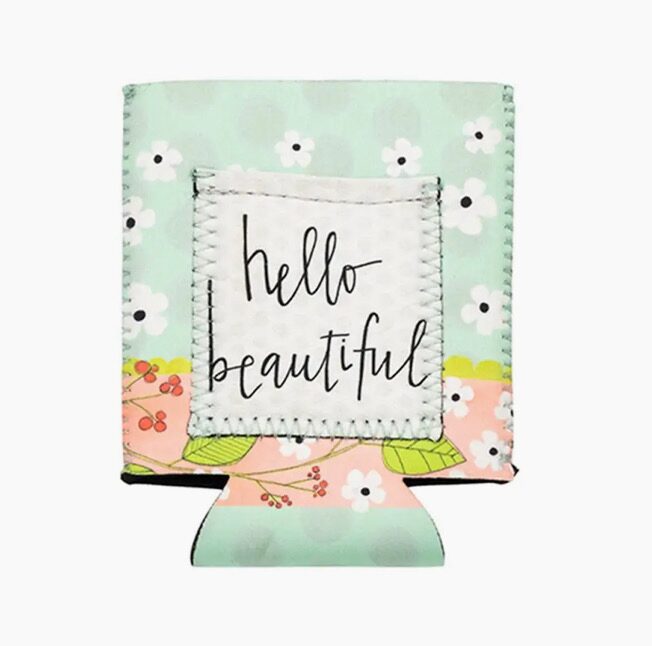 A beverage holder with a floral design and the text "hello beautiful" on the front.