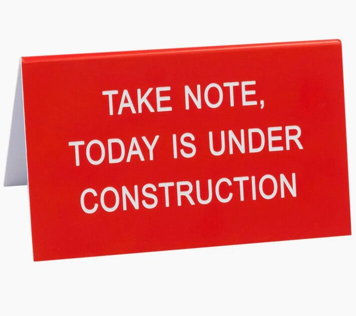 A red sign with white text reads, "Take note, today is under construction.