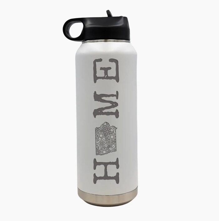 White insulated water bottle with a black lid, featuring the word "HOME" in gray block letters and a design inside the "O.