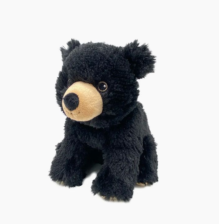 The Black Bear Warmie - Small, featuring a plush design with a light brown snout, is seated against a white background.