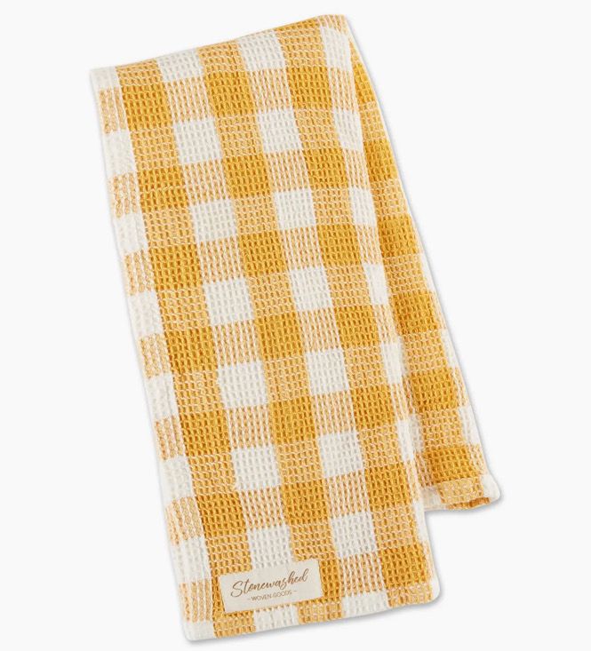 A folded yellow and white checkered waffle weave kitchen towel with a "Stonewall" label in the corner.