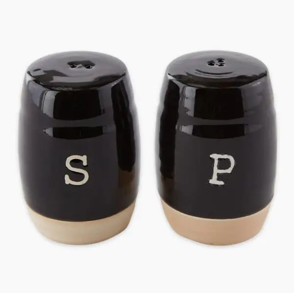 A pair of black ceramic salt and pepper shakers with "S" and "P" on front.